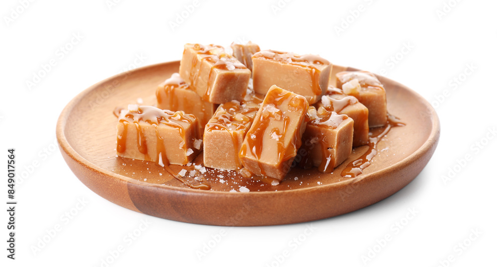 Plate with tasty candies, caramel sauce and salt isolated on white Plate with tasty candies, caramel sauce and salt isolated on white