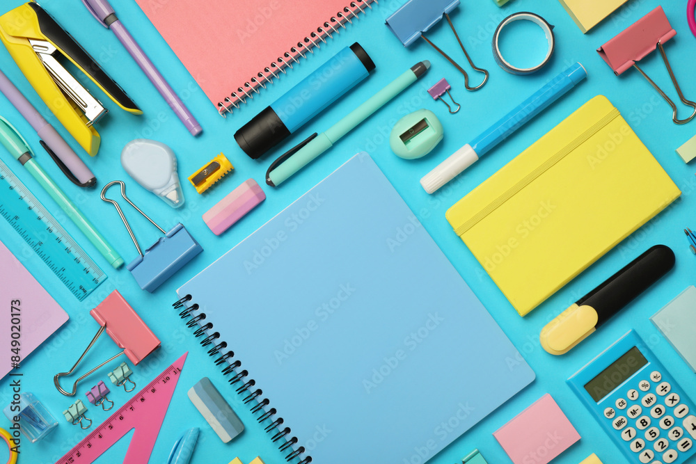 Flat lay composition with notebook and different stationery on light blue background Flat lay composition with notebook and different stationery on light blue background