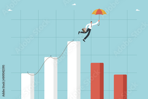 Hold positions during downturn in market activity, look into future to plan further actions, search for strategy for company's operation during economic instability, man with umbrella on falling graph