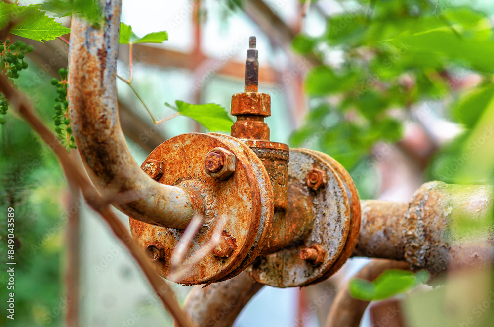 Rusty metal pipe, old water faucet in abandoned building Rusty metal pipe, old water faucet in abandoned building