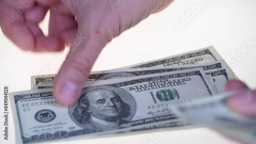 A rich man counts 1000 us dollars on a white background. Hands counting us dollar bills. man hands counting us dollar banknotes close up. 1000 dollars count. count money, count dollars, Money counting