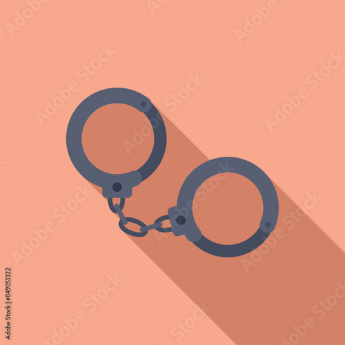 Two metal handcuffs are lying closed on a flat surface, casting a long shadow