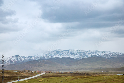 Gannan Tibetan Autonomous Prefecture, Gansu Province - grassland under the snow-capped mountains photo