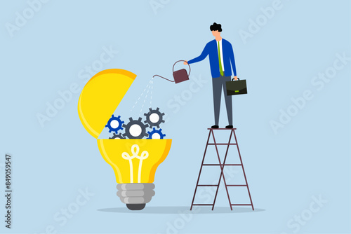 Maintenance brain to generate idea, businessman drops lubricant  into an open ampoule with mechanical gears.