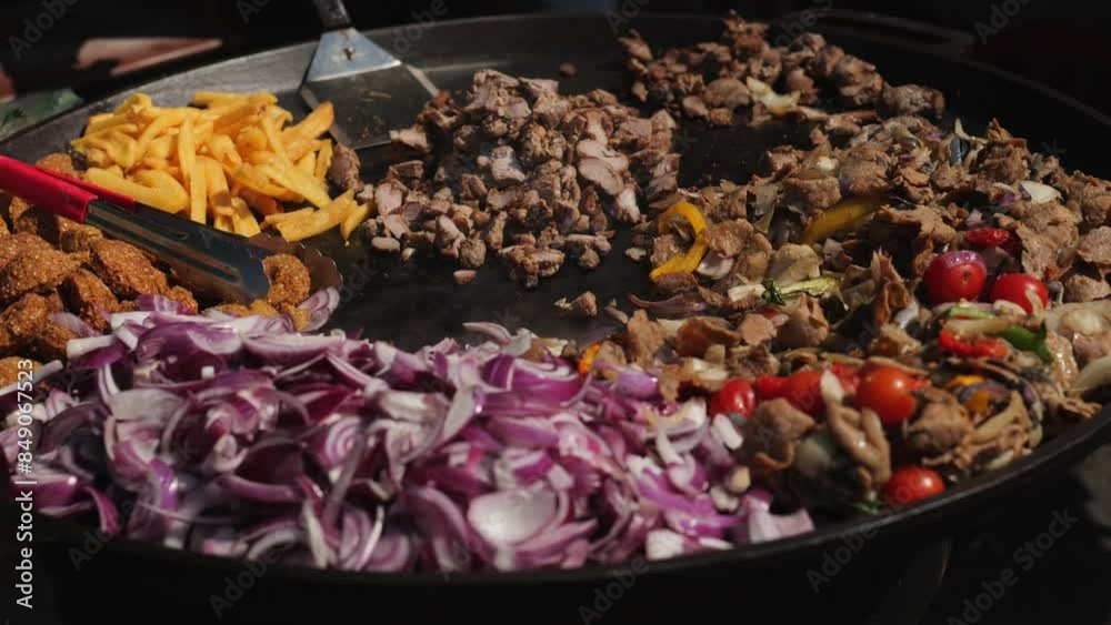The chef roasts meat and vegetables in a frying pan to make Turkish durum food The chef roasts meat and vegetables in a frying pan to make Turkish durum food