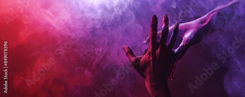 Scary vampire hand reaching out through smoky purple and red atmosphere, creating a haunting and eerie scene.