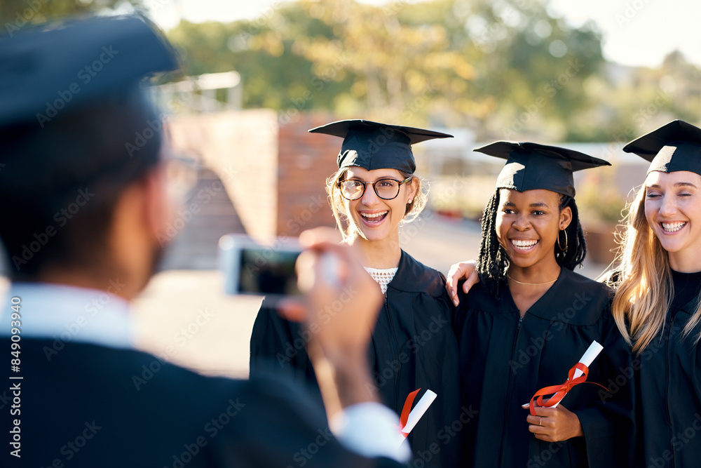 Fototapeta premium People, picture and graduation outside with students, friends and smartphone for memory photo with graduate pride. Happy, smile and together with diploma achievement, university and capture in gown