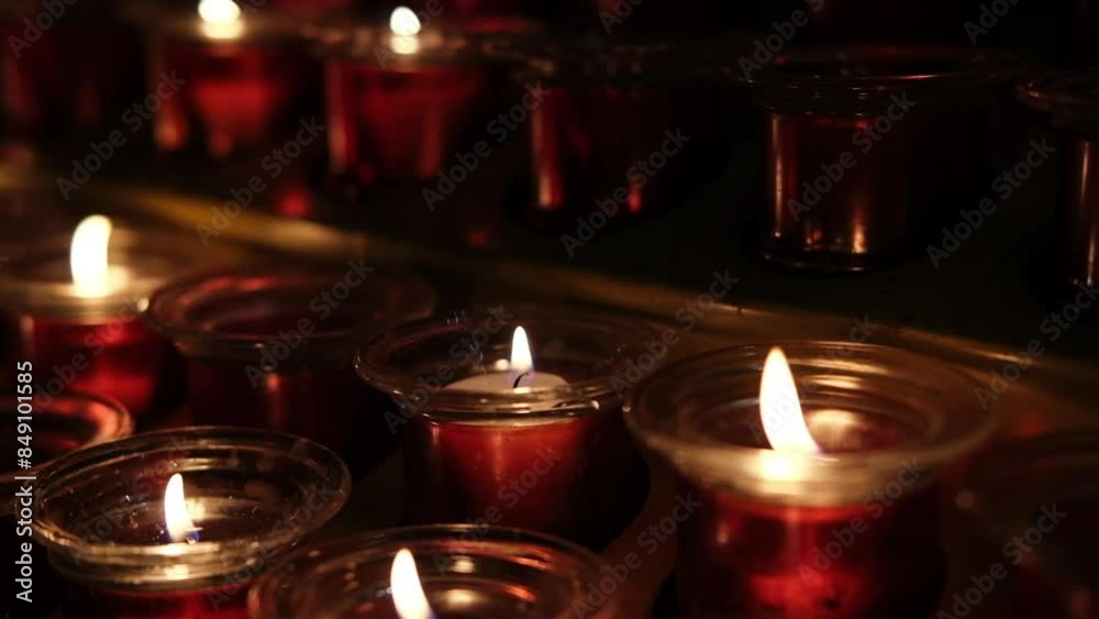 The flame of many lit candles in a Catholic church The flame of many lit candles in a Catholic church