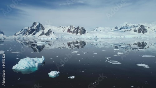 melting antarctic ocean landscape in polar summer snow covered mountains blue sky