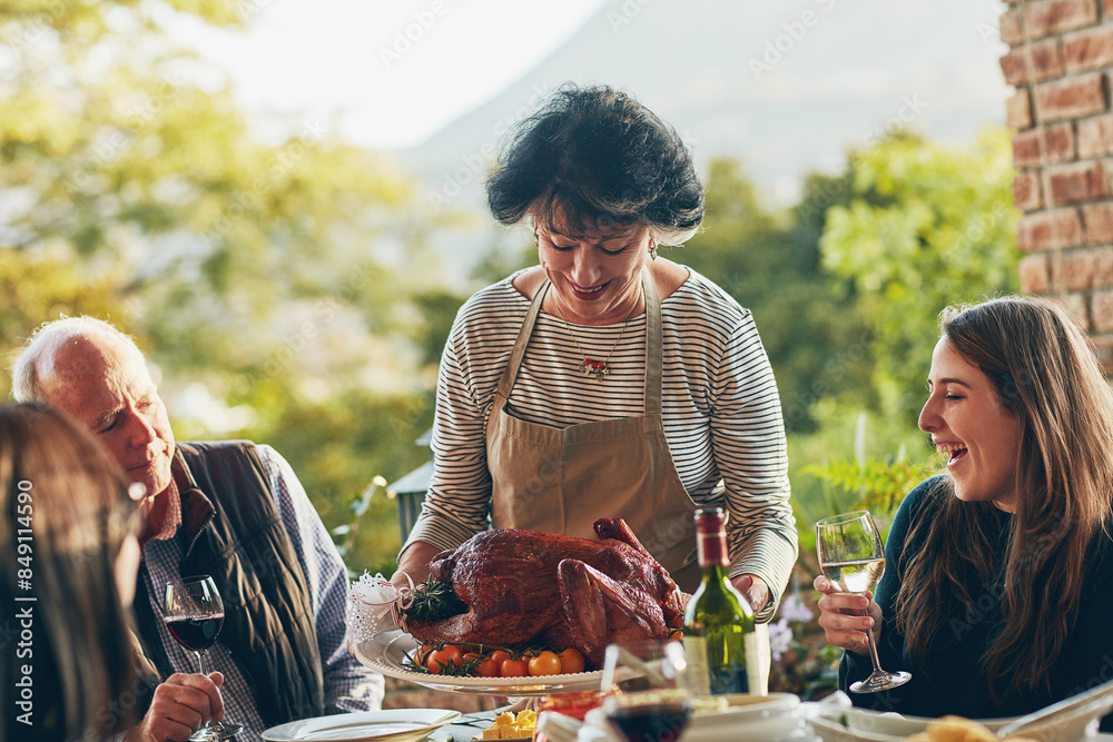 Serving, thanksgiving and woman with turkey for dinner, lunch and food on table outdoor. Happy family, usa tradition and celebration as culture, express gratitude and reflect on blessings in garden Serving, thanksgiving and woman with turkey for dinner, lunch and food on table outdoor. Happy family, usa tradition and celebration as culture, express gratitude and reflect on blessings in garden