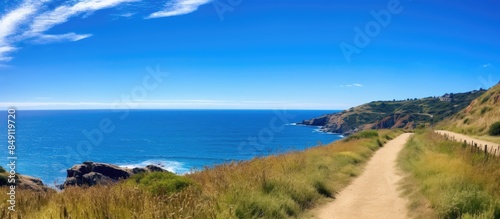 walkway at seaside cliff against blue sea and sky. Creative banner. Copyspace image © HN Works