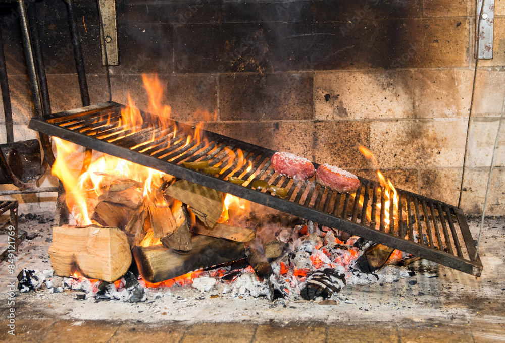 Meat being roasted on a Uruguayan parrilla, in a restaurant Meat being roasted on a Uruguayan parrilla, in a restaurant