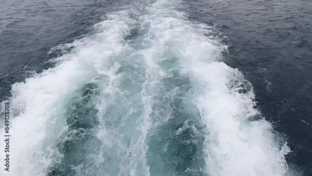 Close up of turbo jets of a boat at speed. Water flows making waves. Water ripples