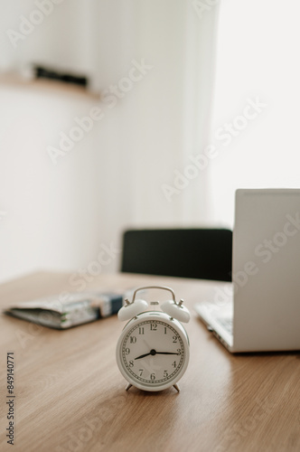 alarm clock on desktop, laptop and notebook for work