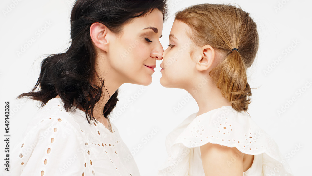 Sensual mother with her little daughter on a light studio background. Family relationship between mother and daughter. Tender moment, family support. Sensual mother with her little daughter on a light studio background. Family relationship between mother and daughter. Tender moment, family support.
