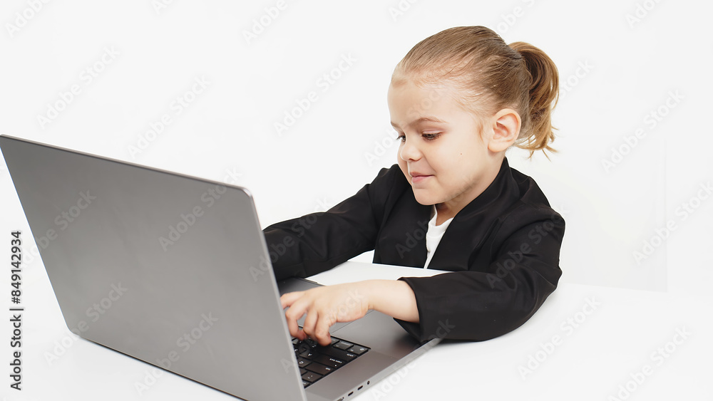 Stylish, business schoolgirl studying at a laptop on an isolated white background. Concept of modern technology, business and education. Stylish, business schoolgirl studying at a laptop on an isolated white background. Concept of modern technology, business and education.