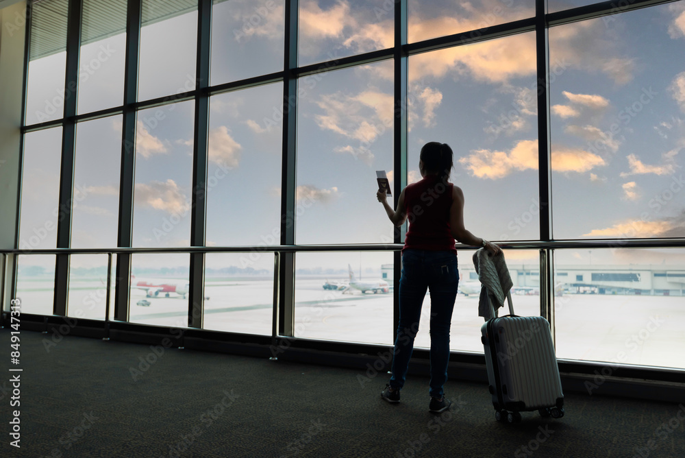 Fototapeta premium Female passenger waiting her flight at airport