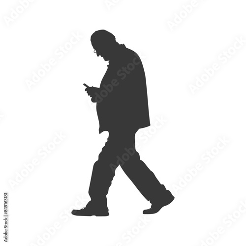 Silhouette of a man walking and using a smartphone.
