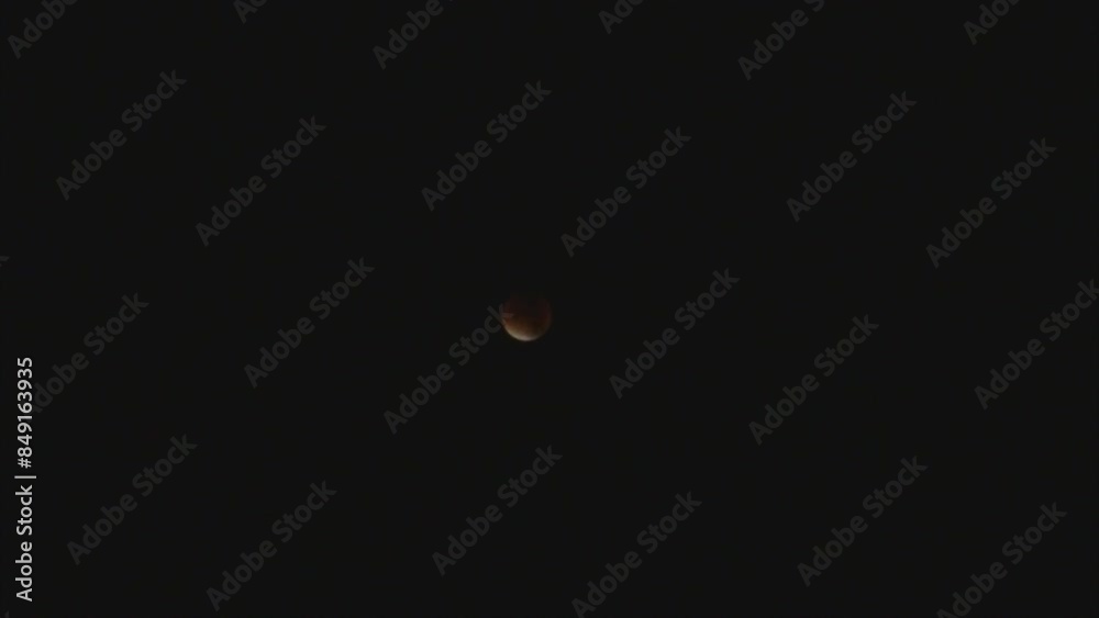 Dark night sky and Supermoon during total lunar eclipse that occurred in month of September 2015 called Harvest Moon - real time. Topics: space, astronomy, light, cosmos, weather Dark night sky and Supermoon during total lunar eclipse that occurred in month of September 2015 called Harvest Moon - real time. Topics: space, astronomy, light, cosmos, weather