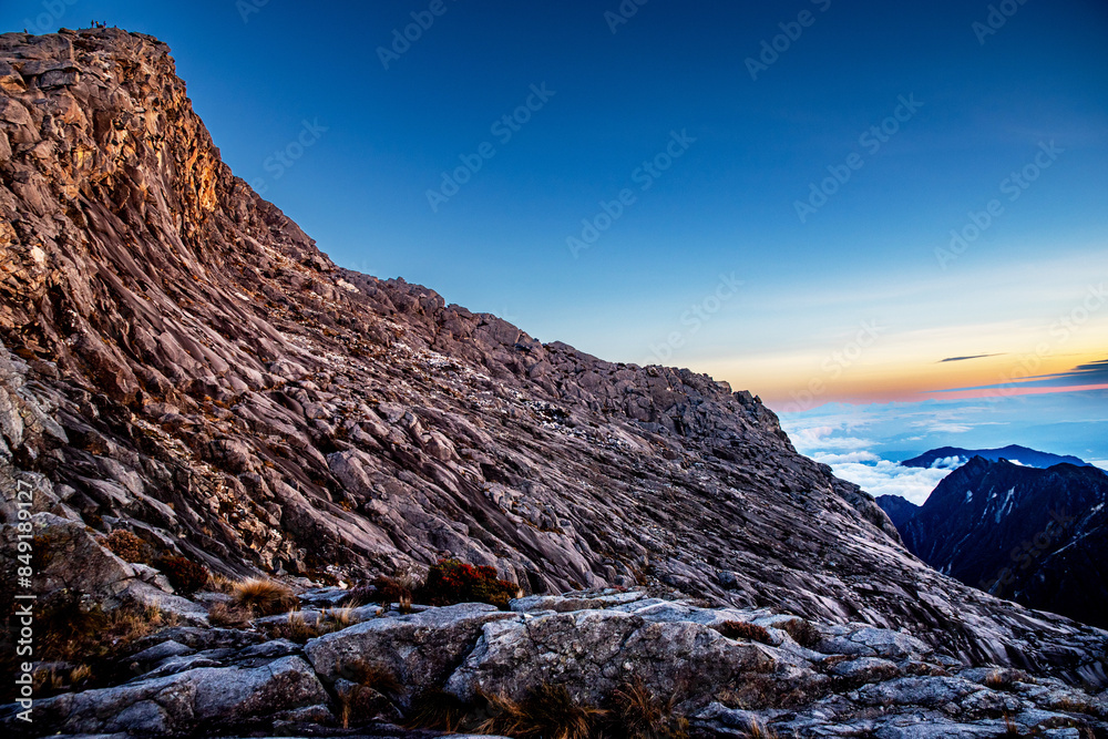 Mount Kinabalu peak with light of sunrise on Mount trip travel, hiking in Kinabalu national park. Kota kinabalu - Malaysia. Mount Kinabalu peak with light of sunrise on Mount trip travel, hiking in Kinabalu national park. Kota kinabalu - Malaysia.