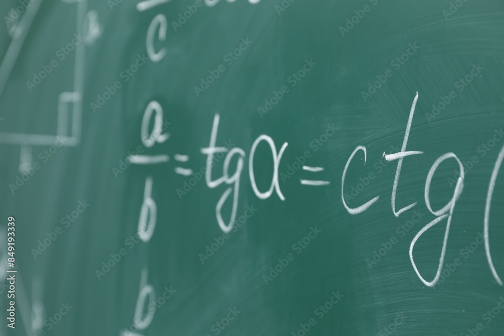 Many different math formulas written on chalkboard Many different math formulas written on chalkboard