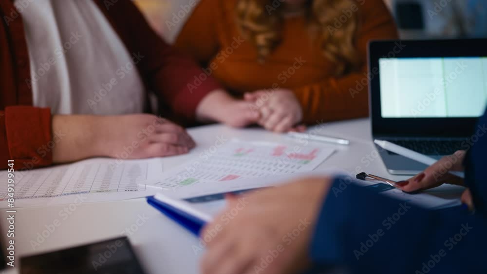 Realtor showing property documents to clients in office, making purchase deal