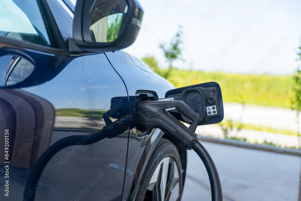 Charging cable plugged in an electric vehicle Charging cable plugged in an electric vehicle