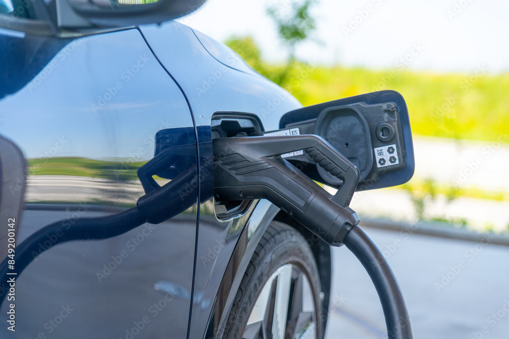 Charging cable plugged in an electric vehicle Charging cable plugged in an electric vehicle