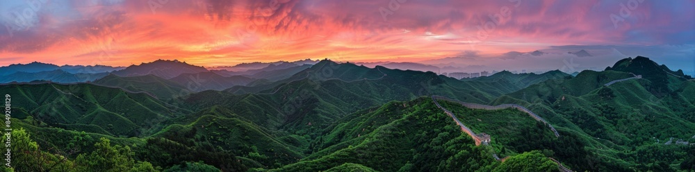 The Great Wall of China at sunrise, with the colorful sky in the background.