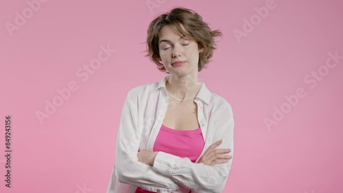 Bored upset woman sighs, rolling eyes on pink backdrop. Pretty lady, displeasure