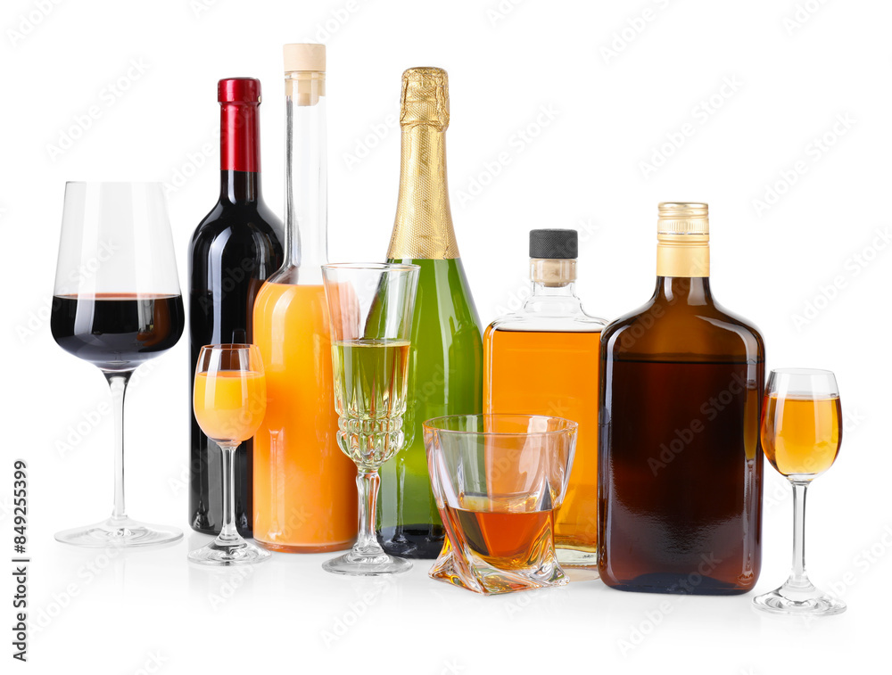 Bottles and glasses with different alcoholic drinks isolated on white Bottles and glasses with different alcoholic drinks isolated on white