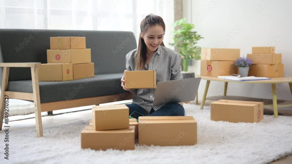 A woman is sitting on the floor in front of a couch and boxes