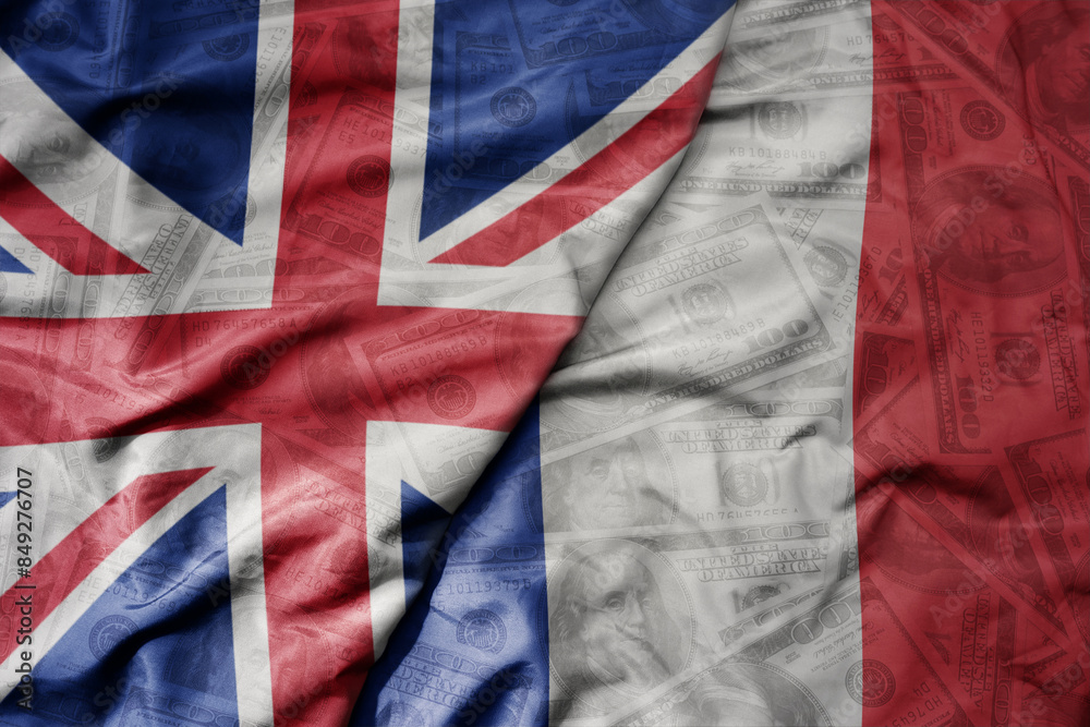 big waving colorful flag of france and national flag of great britain on the dollar money background. finance concept. big waving colorful flag of france and national flag of great britain on the dollar money background. finance concept.