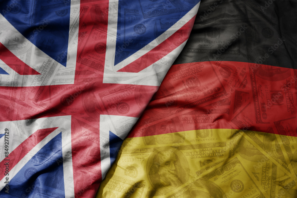 big waving colorful flag of germany and national flag of great britain on the dollar money background. finance concept. big waving colorful flag of germany and national flag of great britain on the dollar money background. finance concept.