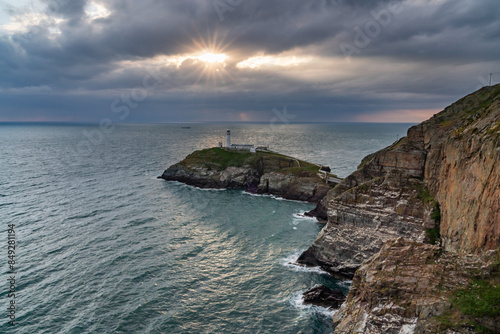 Sun beams around South Stack Lighthouse