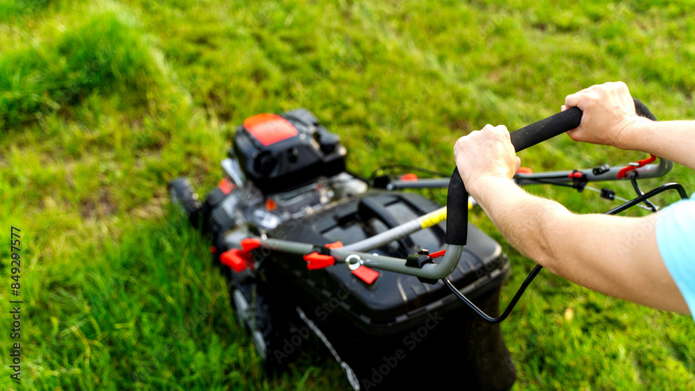 Girl with a lawnmower mows the lawn Girl with a lawnmower mows the lawn