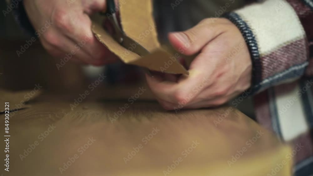 Cardboard and scissors close-up.
A man cuts brown paper with scissors.
Sharp scissors cutting paper Cardboard and scissors close-up.
A man cuts brown paper with scissors.
Sharp scissors cutting paper