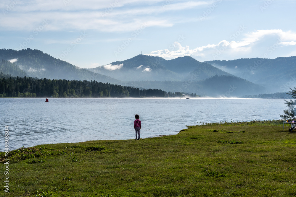 summer panoramic landscape of mountains and forests and lakes against the sky in the area of ​​Lake Teletskoye in Altai