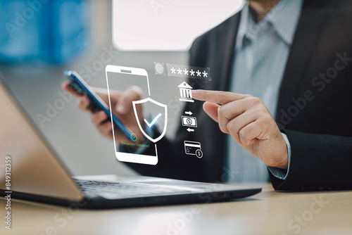 Concept of cyber crime and cyber security. Hand using laptop and smartphone for internet banking money transaction with two-step verification,  authentication, information security and encryption.