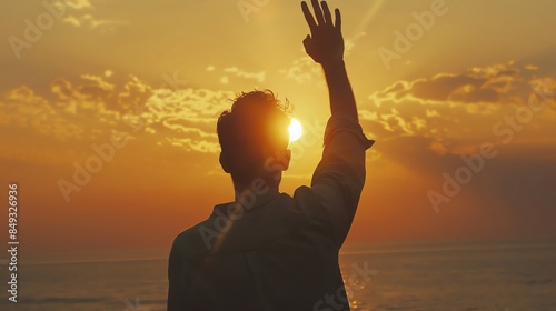 Silhouette of a person waving at a golden sunset by the ocean, capturing a peaceful and heartwarming moment of farewell.