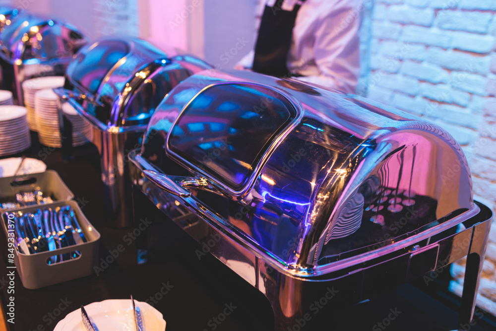Naklejka premium Beautifully decorated catering banquet table with different main course hot food dishes and garnish, with rice, chicken, salmon fish, lamb, vegetables and kebab on party event wedding celebration