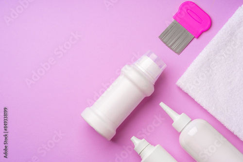 Anti lice combs and towel on pink background photo