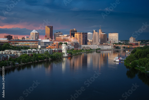 Obraz na płótnie Saint Paul, Minnesota, USA. Aerial cityscape image of downtown St. Paul, Minnesota, USA with reflection of the skyline in Mississippi River at stormy summer sunset. w salonie