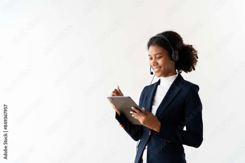 Professional Portrait of a Female Call Center Employee Wearing a Headset and Using a Tablet in a Modern Office Setting Professional Portrait of a Female Call Center Employee Wearing a Headset and Using a Tablet in a Modern Office Setting