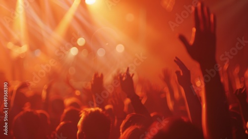 Blurred of Christian worship with raised hand, music concert 