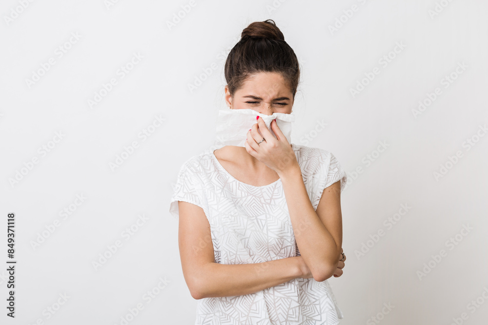 close-up portrait of pretty woman blowing her nose with napkin, catch a cold, feeling sick, isolated, white studio background, frowning close-up portrait of pretty woman blowing her nose with napkin, catch a cold, feeling sick, isolated, white studio background, frowning