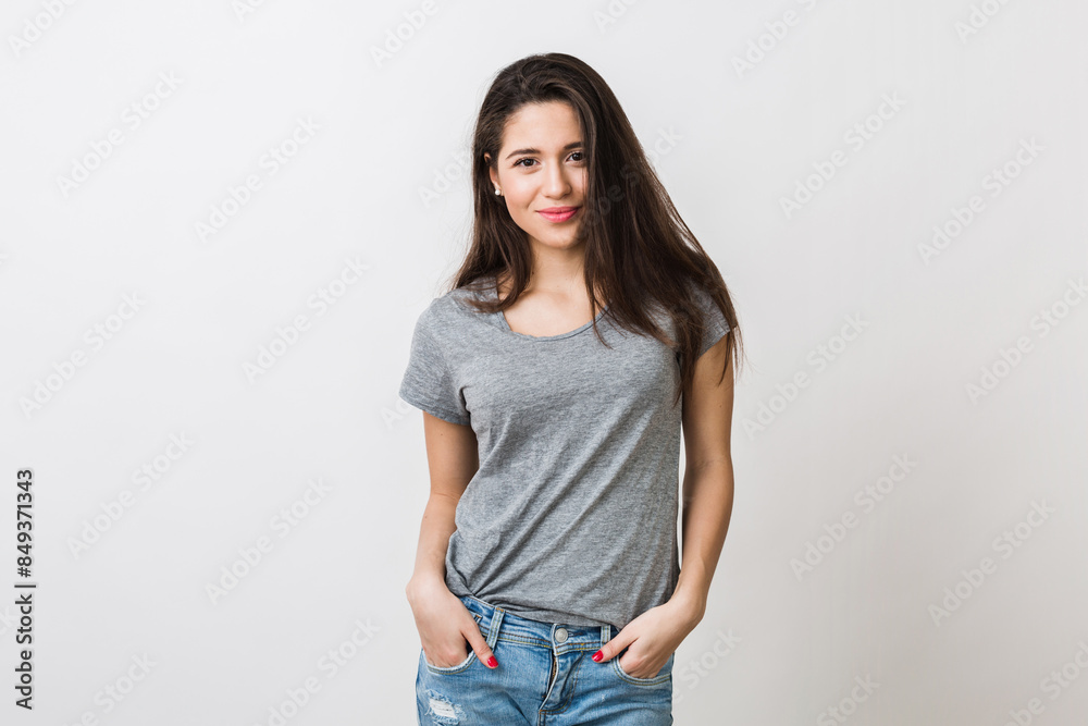 portrait of stylish young pretty woman smiling in grey t-shirt on white studio background, isolated, natural look, long brown hair, jeans, sexy, casual style portrait of stylish young pretty woman smiling in grey t-shirt on white studio background, isolated, natural look, long brown hair, jeans, sexy, casual style