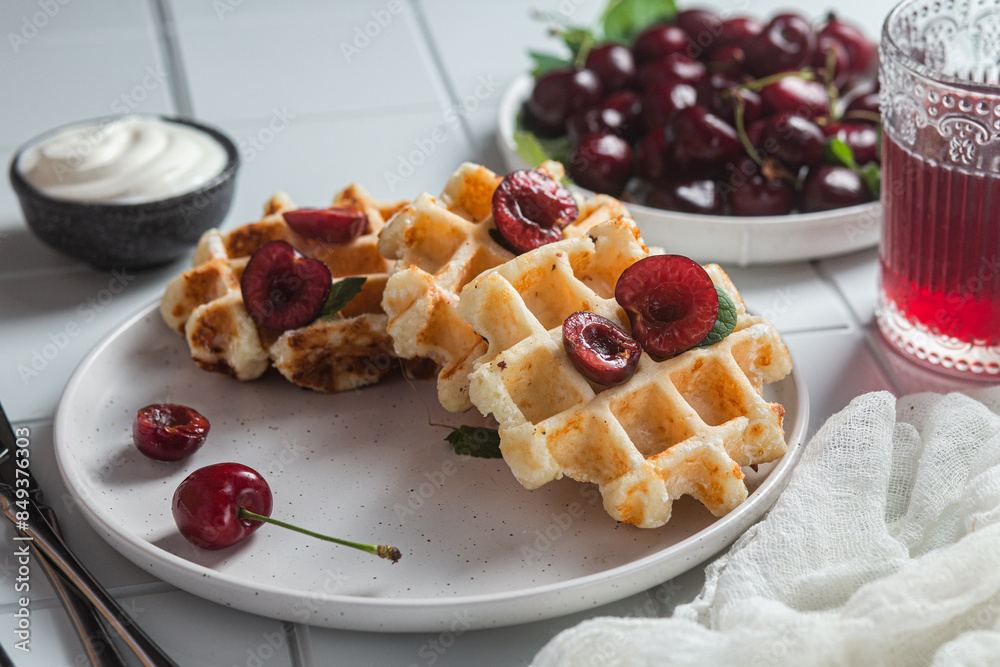 Viennese waffles with cherries on a dark background. Belgian waffles Viennese waffles with cherries on a dark background. Belgian waffles