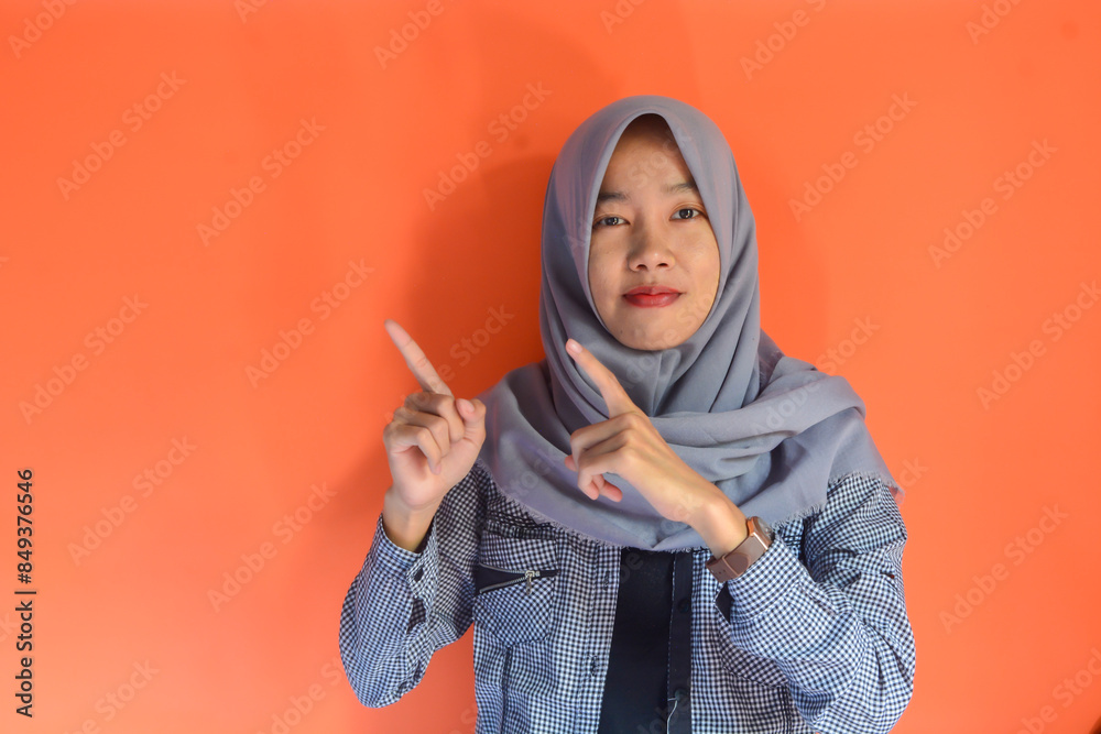 Portrait of a beautiful Asian Muslim woman who is quite thin and looks like a happy, proud and satisfied person Portrait of a beautiful Asian Muslim woman who is quite thin and looks like a happy, proud and satisfied person