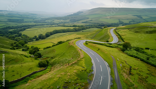 Winding road, top view of beautiful aerial view of asphalt road, highway through forest and fields